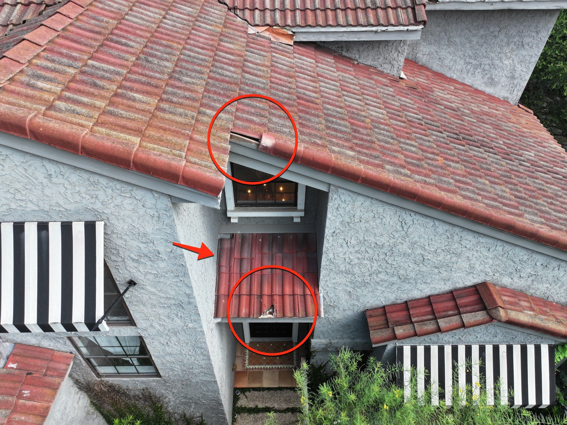 Tile roof damage locations marked on an inspection photo