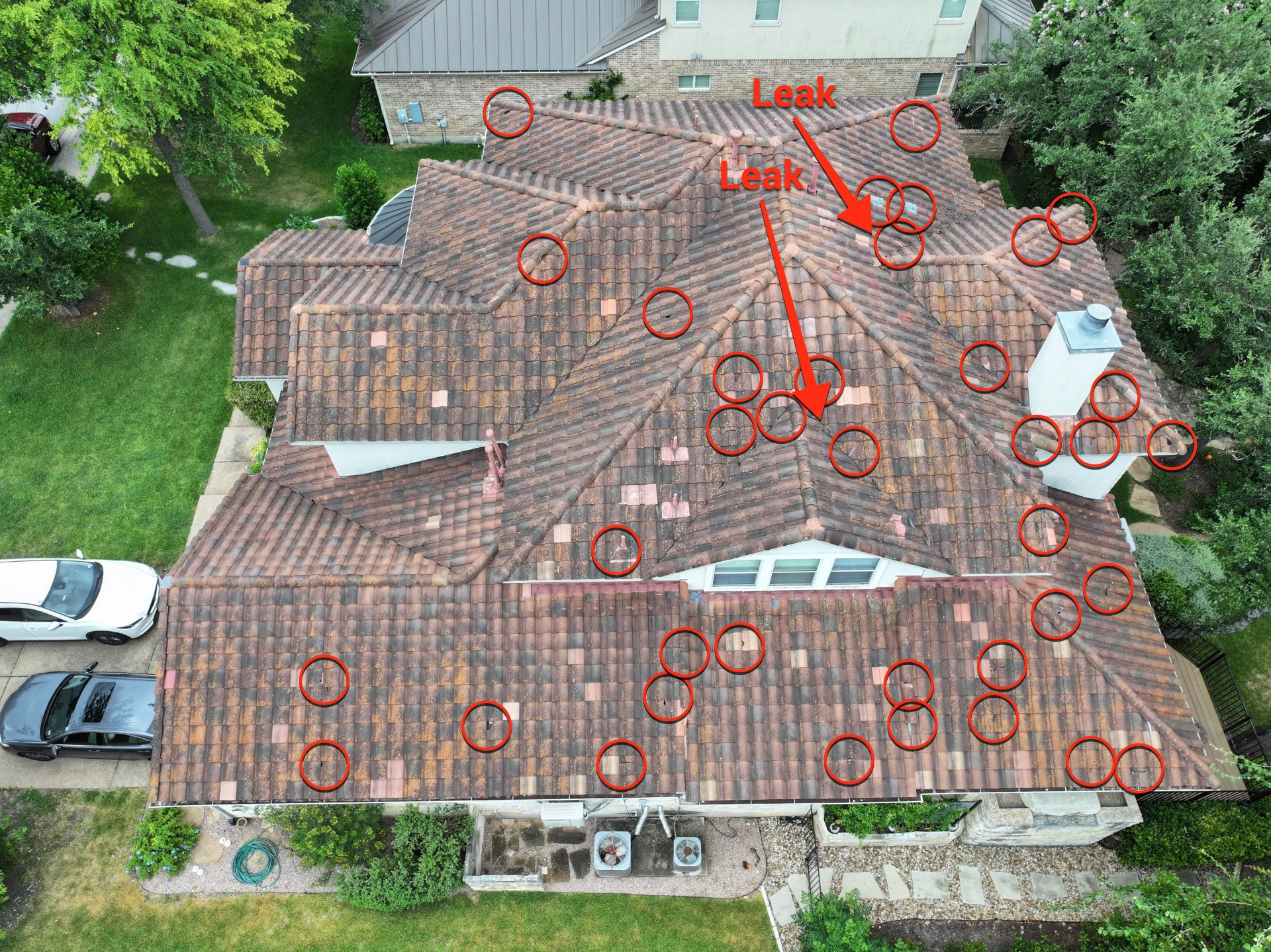 Aerial inspection of a complex tile roof with repair locations identified