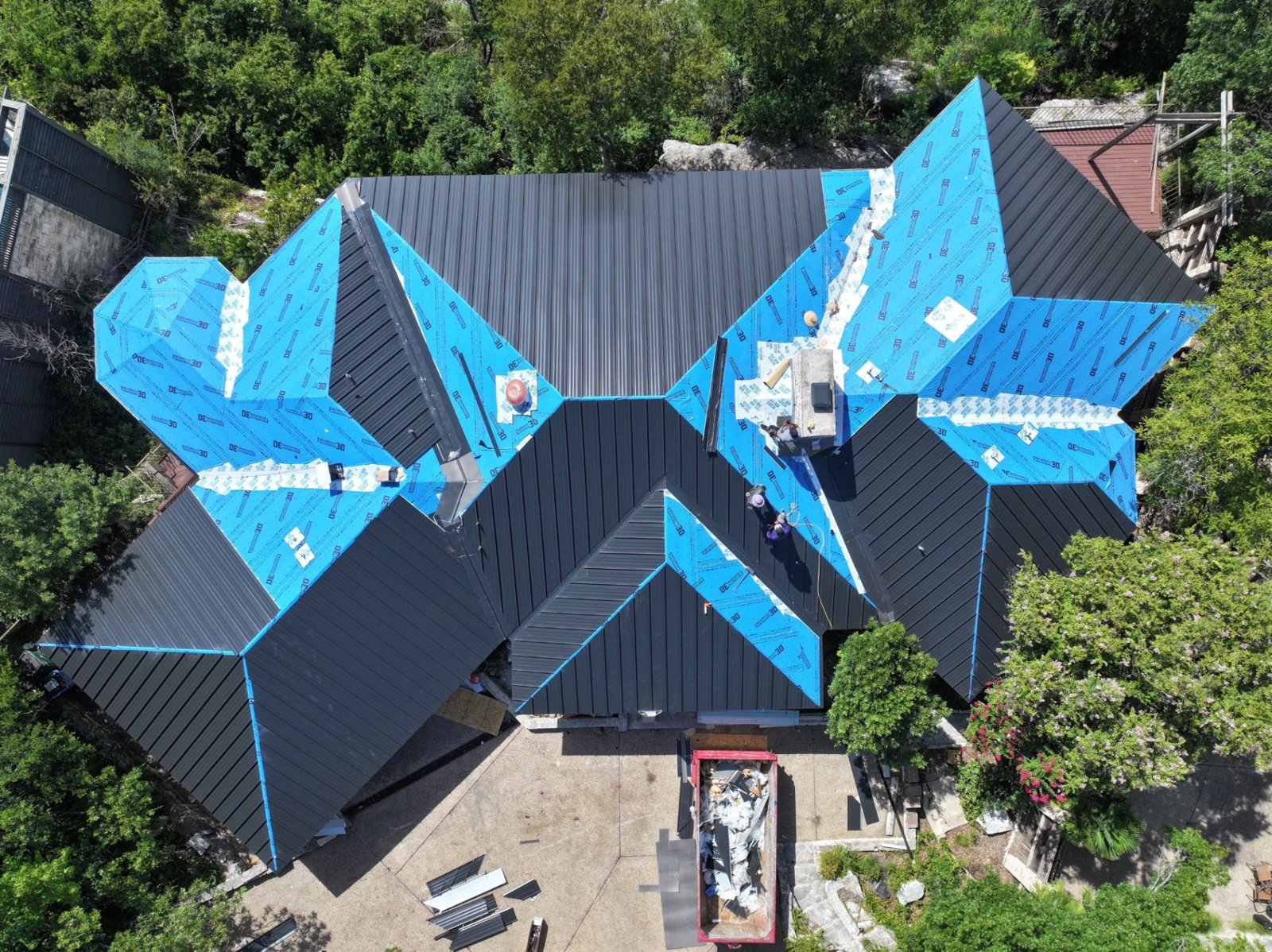 Standing seam panels nearly complete, with the crew finishing the last sections.