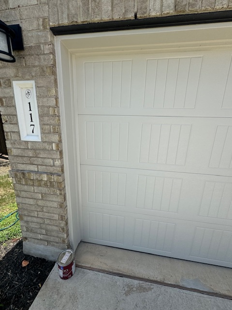 Painted replacement garage door panels and finished left-side trim