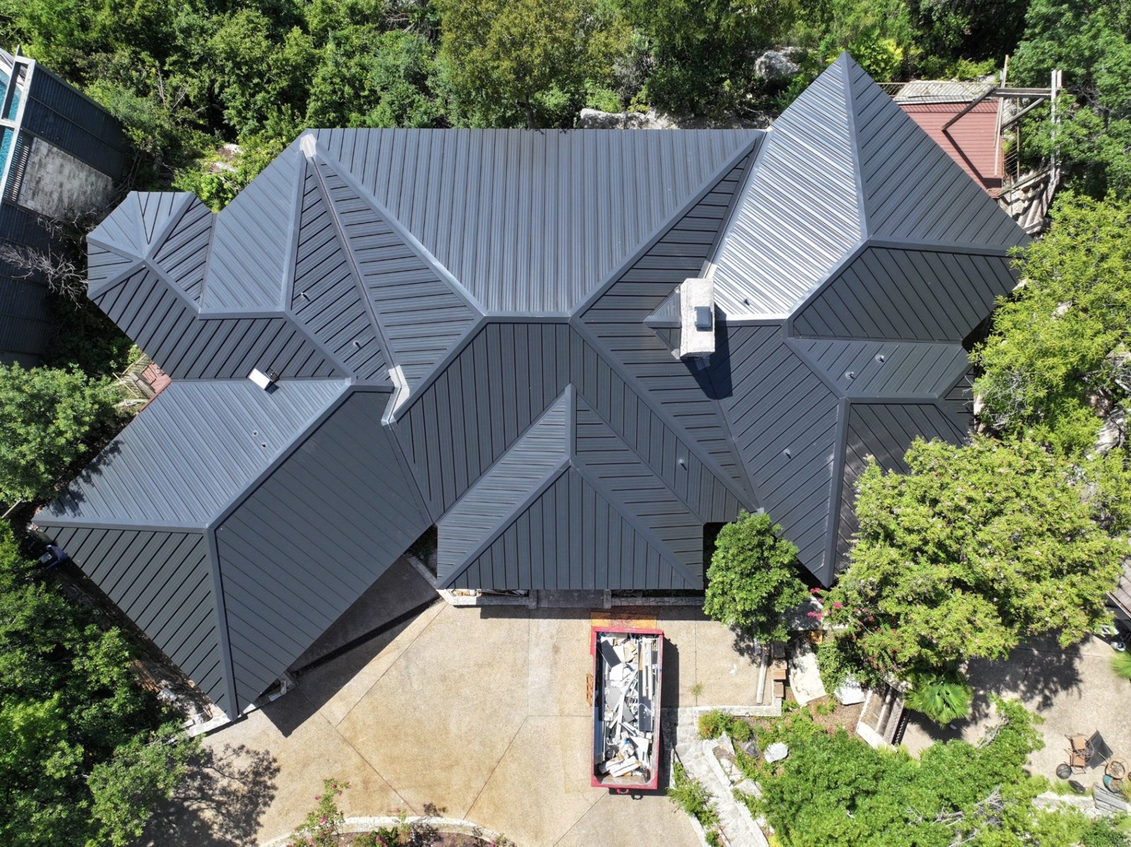 Finished matte black double-lock standing seam metal roof, viewed from above.